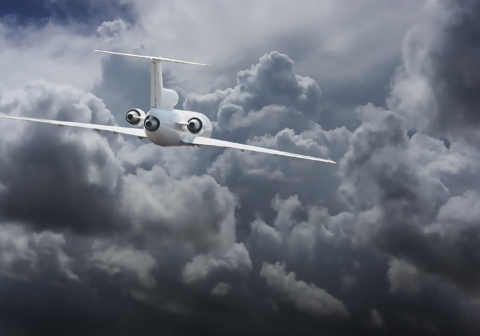 A small jet flies into storm clouds