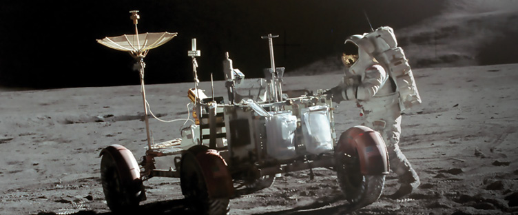 Astronaut James B. Irwin stands near the lunar roving vehicle on the Moon