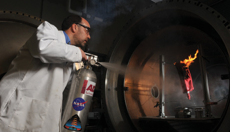 A technician puts out a fire with a fine-water-mist fire extinguisher