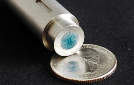The DirectShear sensor, shown sitting on a quarter for scale