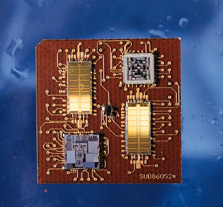 electronic circuit is coated with an inorganic moisture barrier and pictured on a blue background