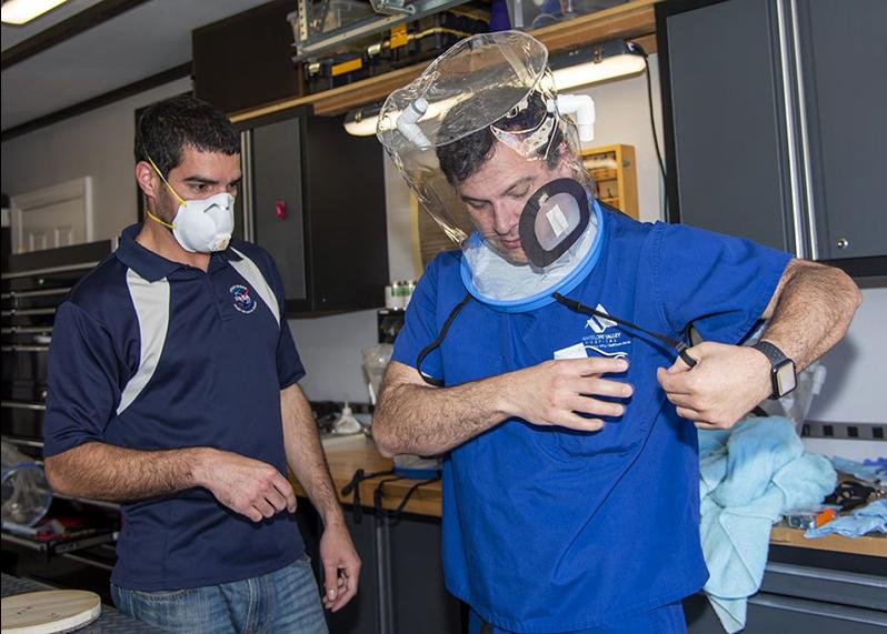 Armstrong Flight Research Center engineer Mike Buttigieg, left, and Dr. Daniel Khodabakhsh of Antelope Valley Hospital trying on the mask