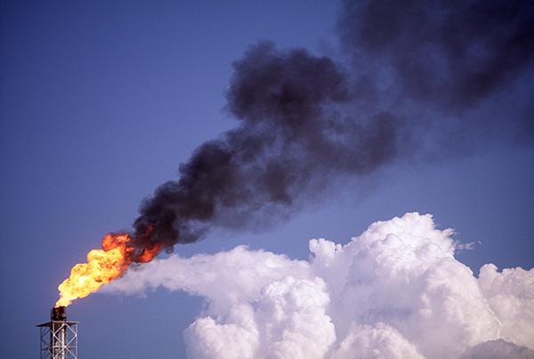 Flaring at drilling sites releases about 350 million tons of carbon dioxide per year and is associated with health problems nearby. However, if properly processed and separated, the gas can instead be valuable fuel. Credit: jmsilva via Getty Images Flare stack with white cloud in background at oil refinery