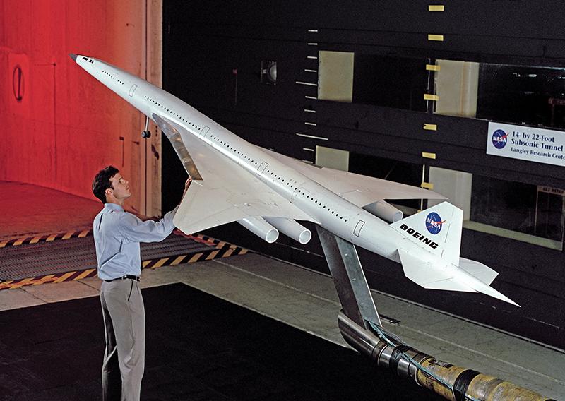 In the 1990s, Langley Research Center was looking for polymers to make building and operating supersonic airliners more viable. Now, a derivation from that materials research called MP1 is being tested in hip replacements. Credit: NASA Engineer with model aircraft