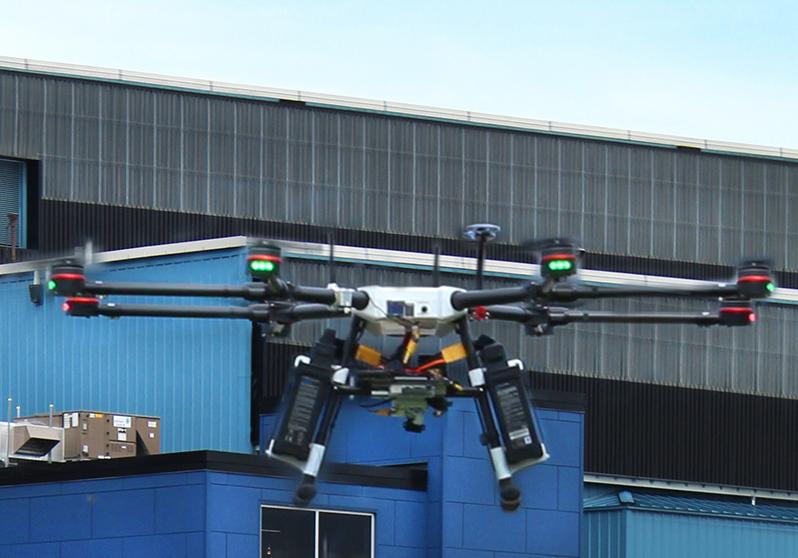 A drone flying in front of a building