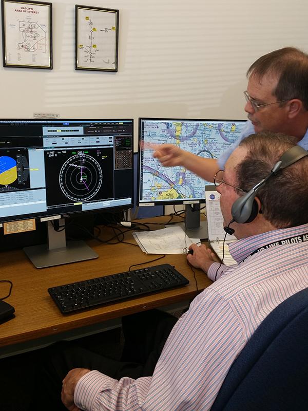 NASA’s Jim Chamberlain (retired) and a pilot work through a mission scenario with a set of NASA-developed detect-and-avoid algorithms known as DAIDALUS. The Beavercreek, Ohio-based CAL Analytics team was visiting NASA’s Langley Research Center to observe an unofficial evaluation of the system. Credit: CAL Analytics/Sean Calhoun NASA’s Jim Chamberlain (retired) and a pilot work through a mission scenario