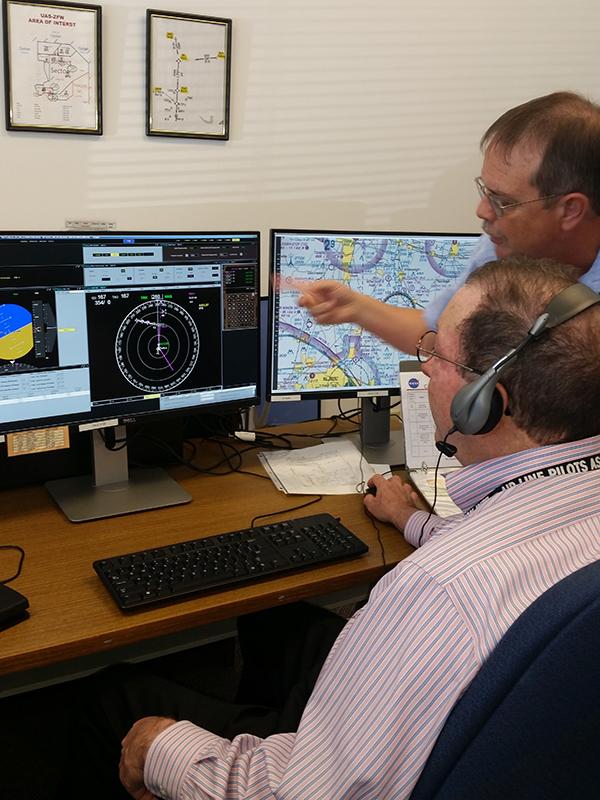 NASA’s Jim Chamberlain (retired) and a pilot work through a mission scenario