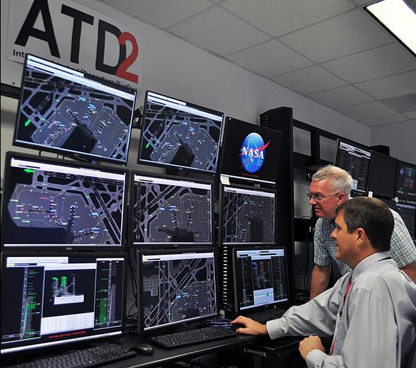 The focus of Airspace Technology Demonstration 2 (ATD-2) was Integrated Arrivals Departures Scheduling (IADS), a software that coordinates flight schedules between the ramp, tower, terminal, and center control facilities. This visual representation of data helps minimize delays on the ground. Credit: NASA Engineers using ATD-2 software on multiple monitors