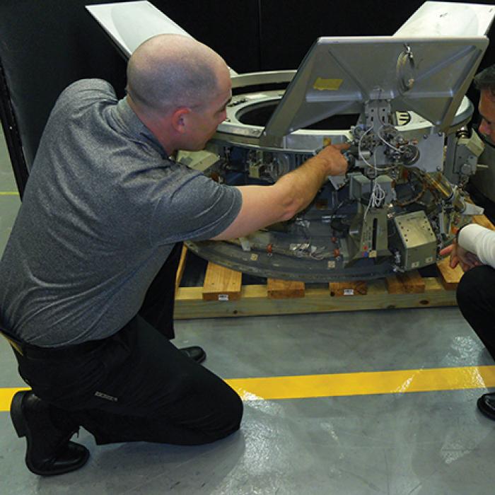 A payload specialist trains a researcher on how to pack payloads