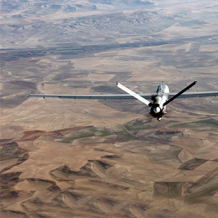 A drone flying over an arid stretch of land