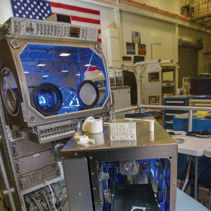 The prototype 3D printer for microgravity with samples of products