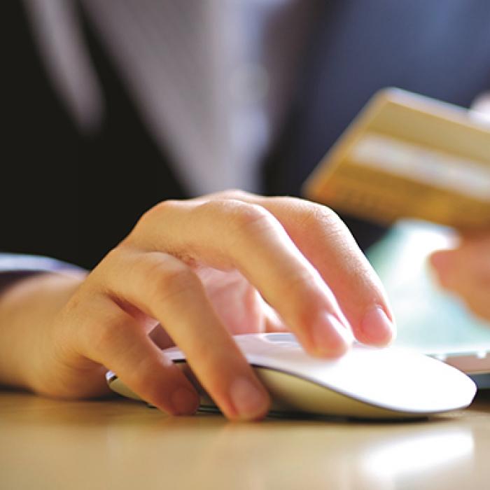 Woman with credit card and computer mouse