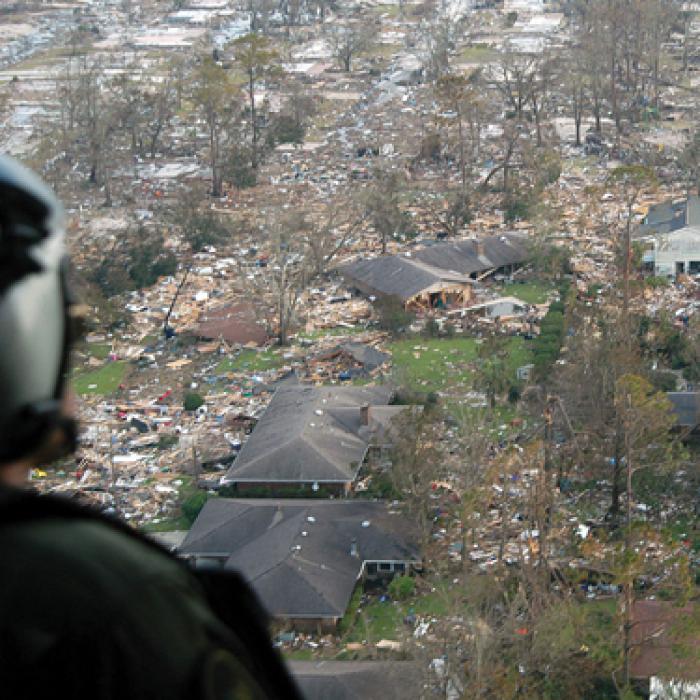U.S. Navy crewmen surveying damage from Hurricane Katrina