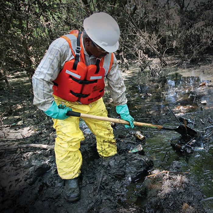 Worker cleaning an oil spill