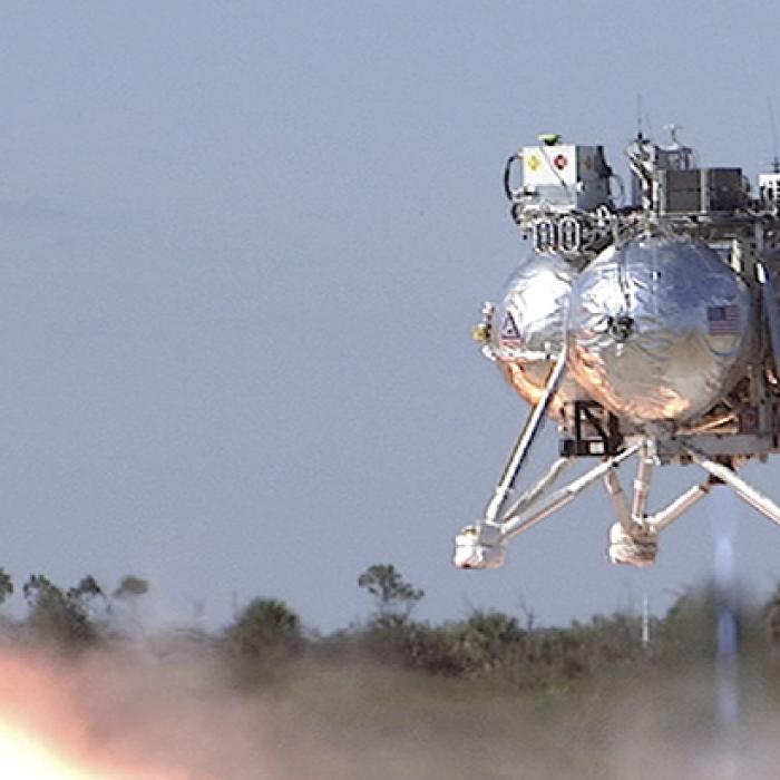 Prototype lunar lander Morpheus hovers above the ground during a test flight