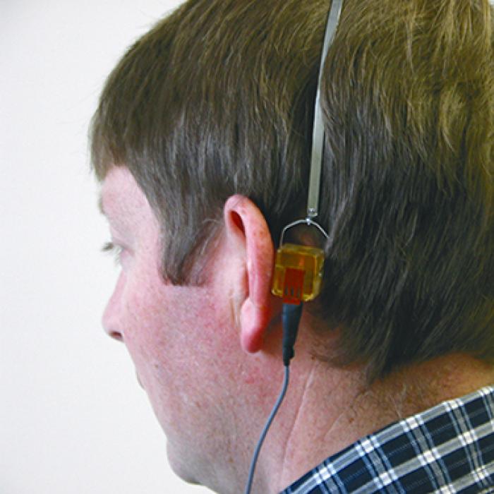 A man wearing hearing test equipment
