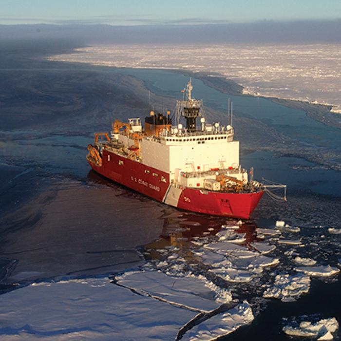 A U.S. Coast Guard cutter moves through Arctic ice.