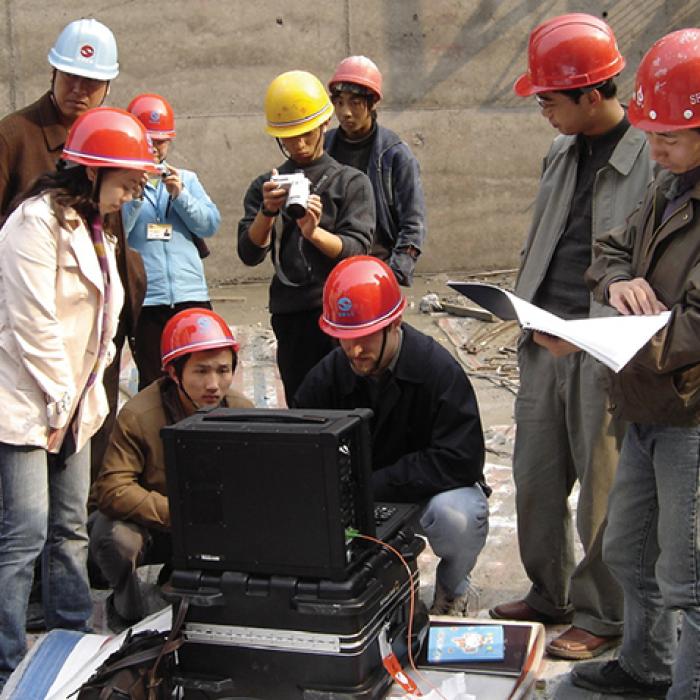 A group of engineers gathers to collect temperature data using the SensorTran 5100 on the Yu River dam construction project in the Guizhou Province of China. Engineers use Sensor Tran system to collect temperature data for a dam project