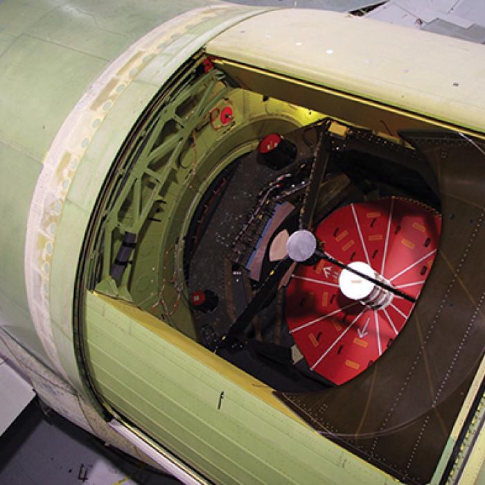 The infrared (IR) telescope of the Stratospheric Observatory for Infrared Astronomy (SOFIA) peers through the opening in the fuselage of its Boeing 747 mothership. NASA's SOFIA infrared telescope on board its airplane mothership