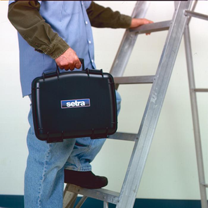 A person carrying the calibration system up a ladder