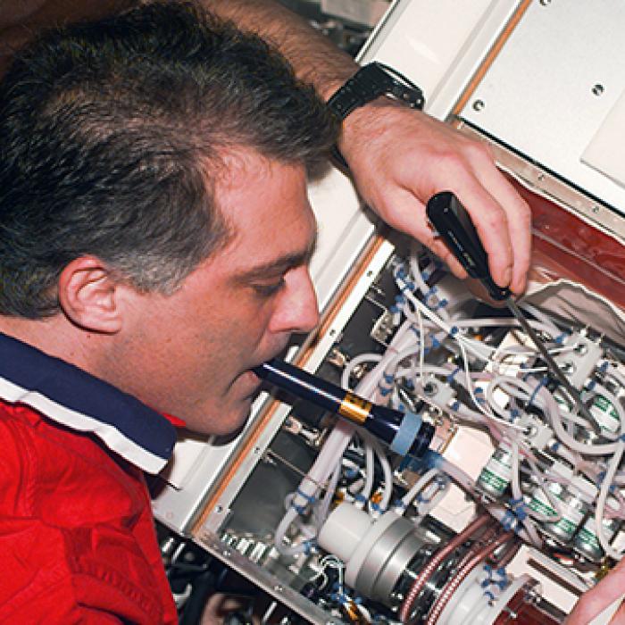 Astronaut with a bioreactor unit