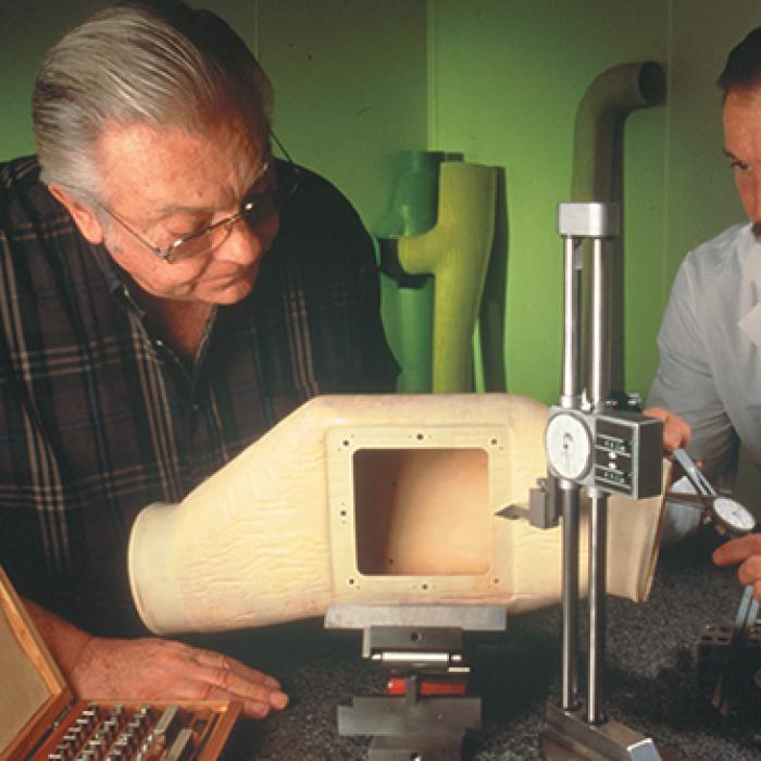 Two men conduct a quality control test on the Ultra Seal Duct component