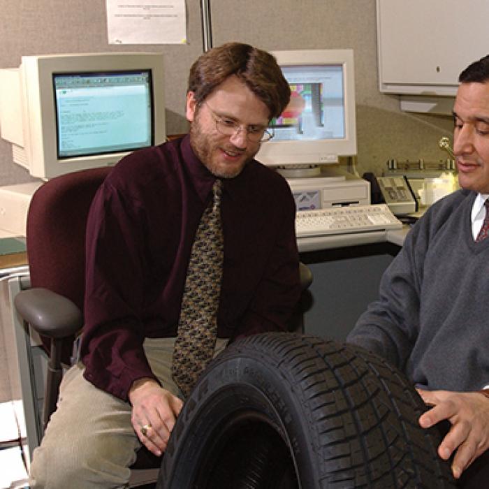 NASA's Dr. Steven Arnold (left) and Goodyear Tire & Rubber Co.'s Dr. Mahmoud Assaad inspect a MAC-manufactured tire