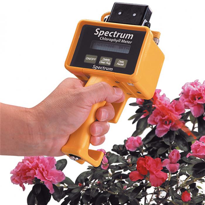 The Observer hand-held device pointed at a flowering shrub