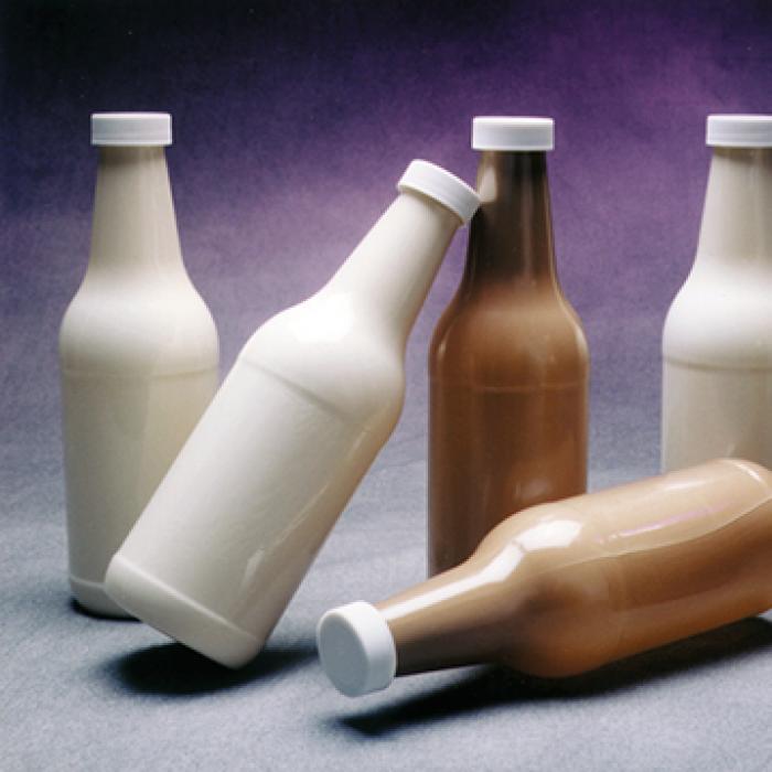 Various bottles, standing and on their sides, created from liquid polymers