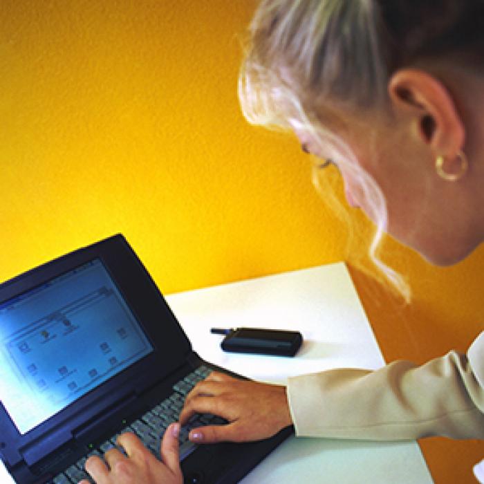 A nurse uses Home Care Connect with a laptop and the Internet