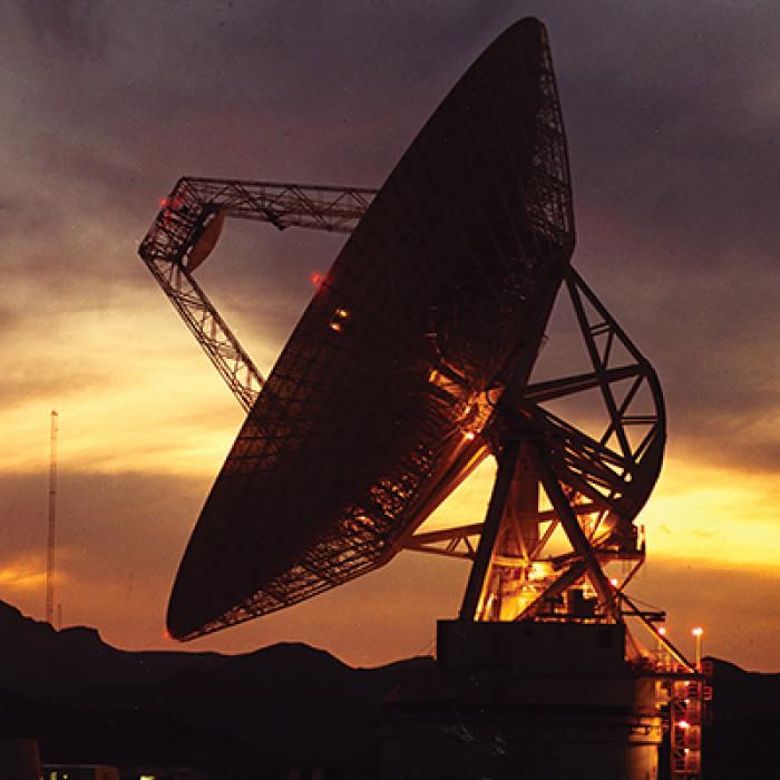 Large satellite dish at sunset