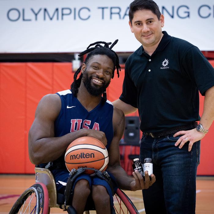 Matt Scott, a five-time Paralympian and a double gold Paralympic medalist, poses with Carlos Montesinos, managing director and chief scientist at Nugevity