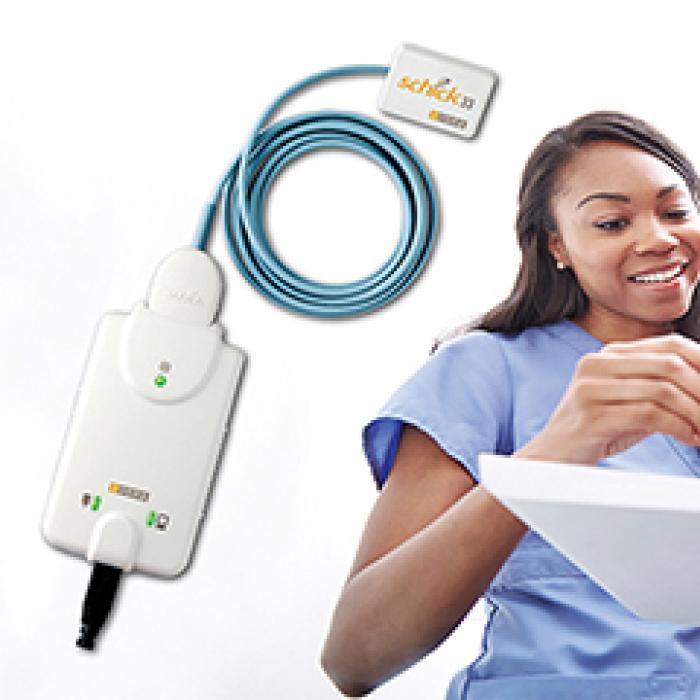 Medical professionals holding a Medical professionals holding a Schick dental imager