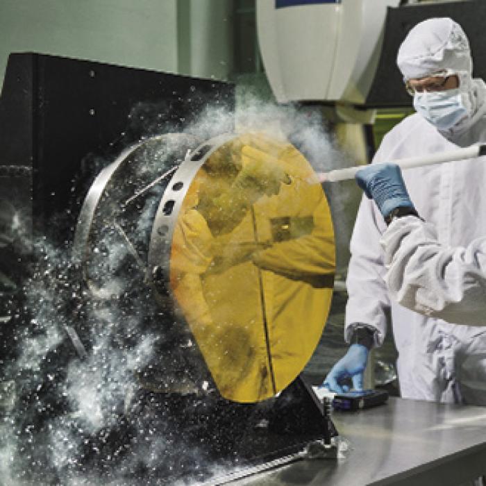 Engineers cleaning test mirror