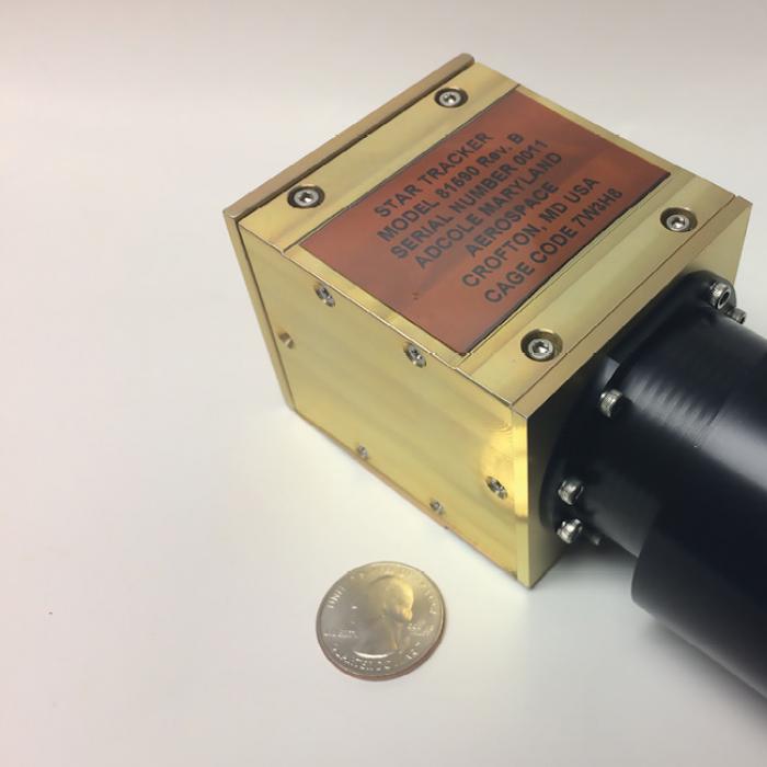 Adcole Maryland Aerospace’s single-camera startracker, with a quarter shown for scale