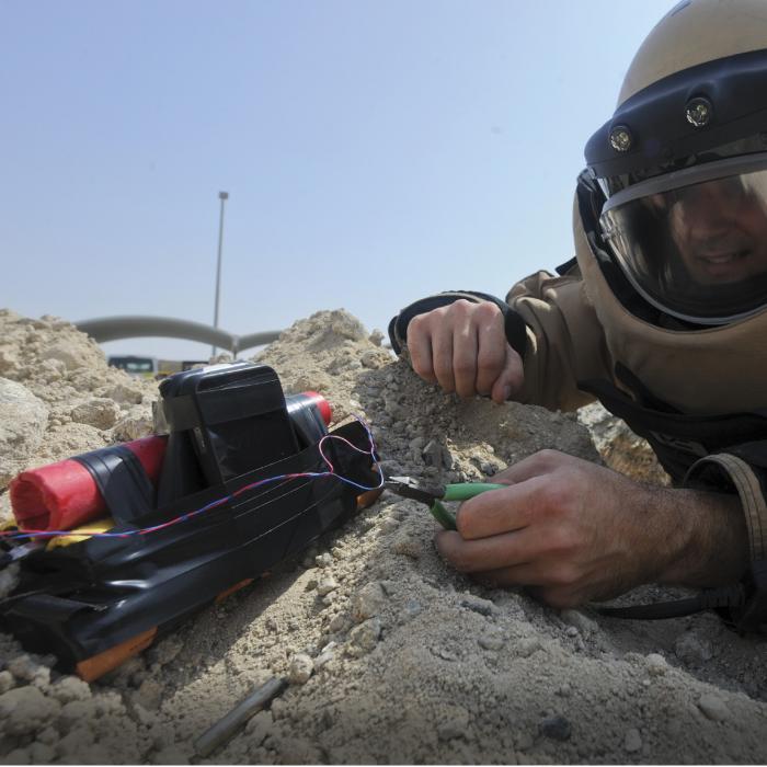 An explosive ordnance disposal worker diffuses a bomb