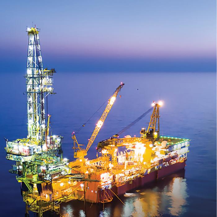 An offshore oil platform is lit up at night