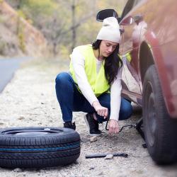 Woman changing a tire