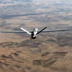 A drone flying over an arid stretch of land