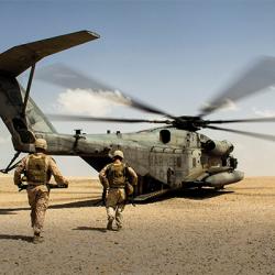 Soldiers run toward helicopter