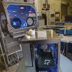 The prototype 3D printer for microgravity with samples of products