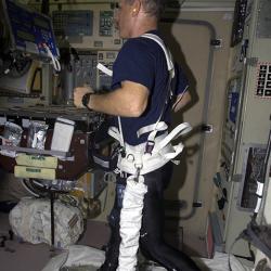 Astronaut Ken Bowersox runs on a treadmill using a loading harness