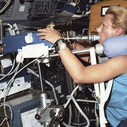 Astronaut Rhea Seddon performs cardiovascular experiments in space.