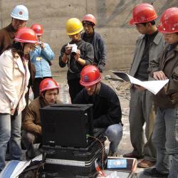A group of engineers gathers to collect temperature data using the SensorTran 5100 on the Yu River dam construction project in the Guizhou Province of China. Engineers use Sensor Tran system to collect temperature data for a dam project