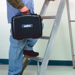 A person carrying the calibration system up a ladder