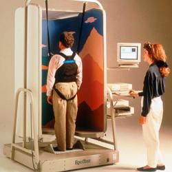 A man stands in the EquiTest System sling while a technician stands at the controls