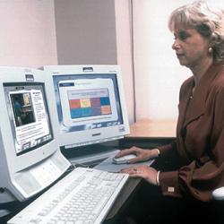 A woman undergoes on-the-job training on a computer
