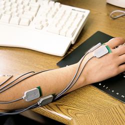 Arm wearing MyoMonitor and using computer mouse
