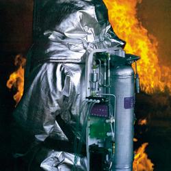 A person surrounded by flames wearing SCAMP, a self-contained breathing apparatus