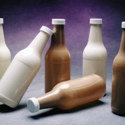 Various bottles, standing and on their sides, created from liquid polymers